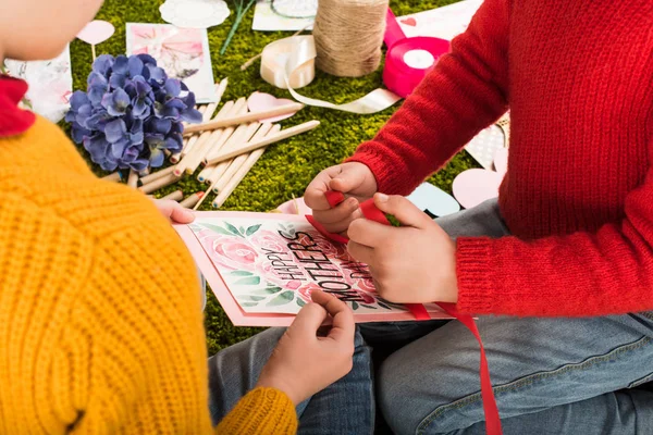 Cropped shot of little kids preparing greeting card for mothers day — Stock Photo