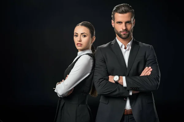Confident businesspeople with crossed arms, isolated on black — Stock Photo