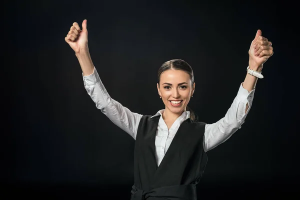 Giovane donna d'affari allegra gesticolando e celebrando il successo, isolata sul nero — Foto stock