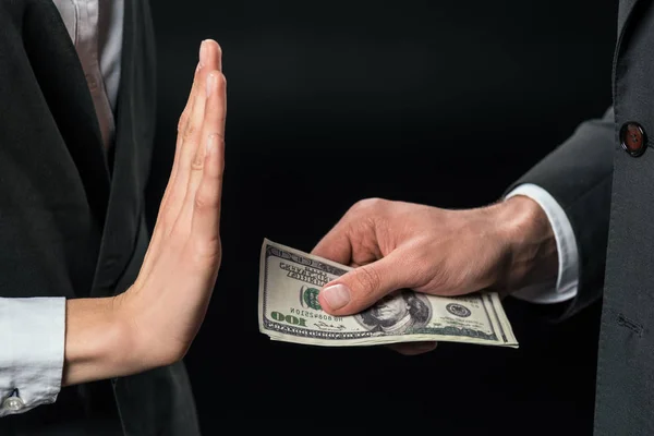 Cropped view of businesswoman refusing to take bribe from partner, isolated on black — Stock Photo