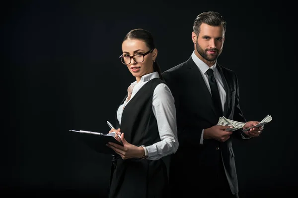 Businesspeople holding contract and dollar banknotes, isolated on black — Stock Photo