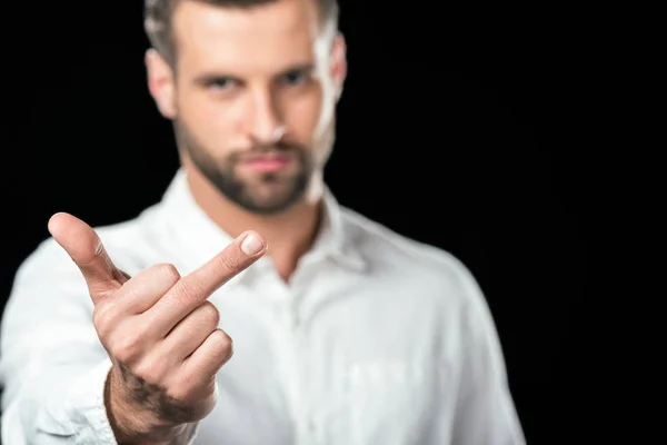 Selective focus of man showing middle finger, isolated on black — Stock Photo