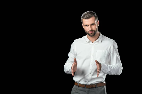 Handsome businessman gesturing isolated on black — Stock Photo