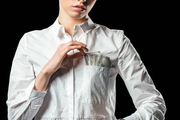 Vista ritagliata di donna d'affari con banconote in dollaro in tasca, isolato su nero — Foto stock