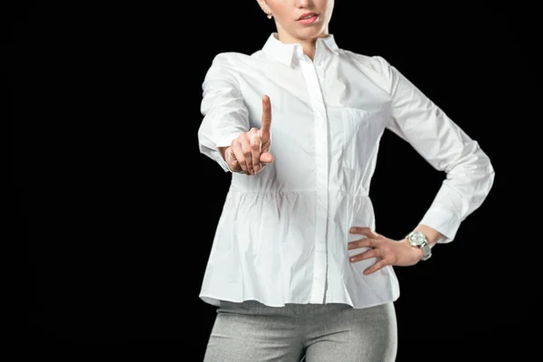 Cropped view of businesswoman pointing up, isolated on black — Stock Photo