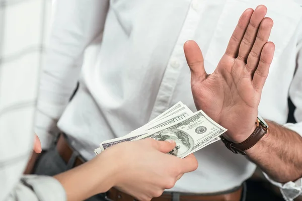 Cropped view of businessman refusing to take bribe from partner, isolated on black — Stock Photo