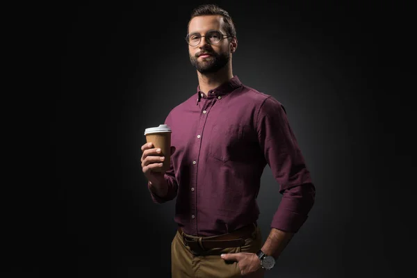Portrait of businessman in eyeglasses with coffee to go isolated on black — Stock Photo