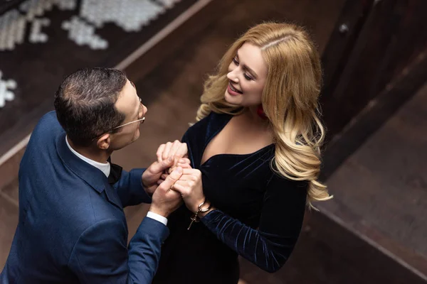 High angle view of beautiful adult couple holding hands — Stock Photo