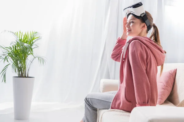 Side view of girl with virtual reality headset looking away at home — Stock Photo