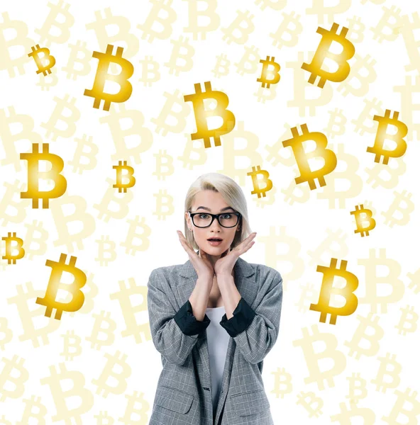 Beautiful shocked businesswoman posing in formal wear and bitcoin symbols on white — Stock Photo