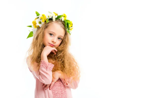 Stylish kid with hand on chin wearing wreath band from flowers isolated on white — Stock Photo