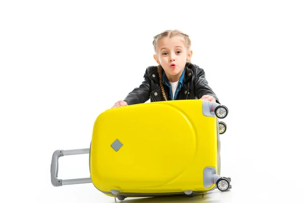 Excited little tourist holding yellow wheel suitcase isolated on white — Stock Photo
