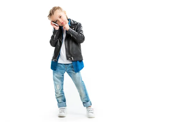 View of kid talking on smartphone and holding finger on chin isolated on white — Stock Photo