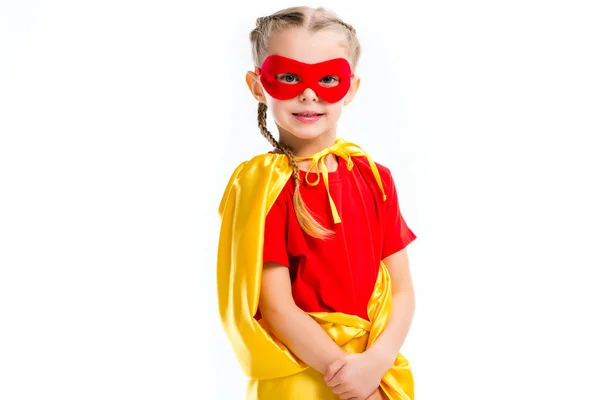 Portrait of little supergirl wearing yellow cape and red mask for eyes isolated on white — Stock Photo