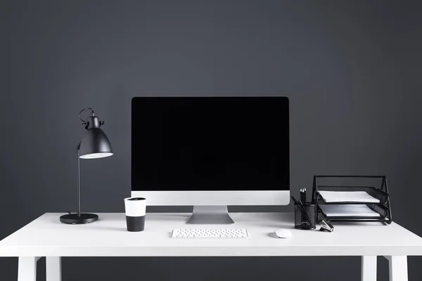 Modern desktop computer with blank screen with keyboard and computer mouse at workplace — Stock Photo