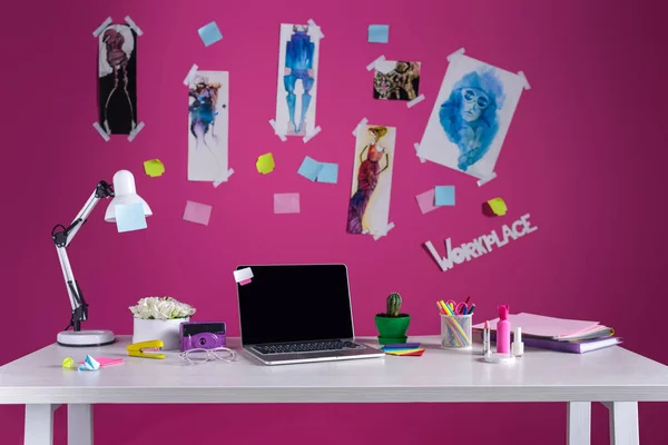 Modern designer workplace with fashion sketches and laptop on table — Stock Photo