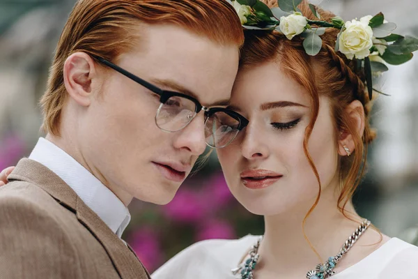 Close-up portrait of beautiful tender young redhead wedding couple — Stock Photo