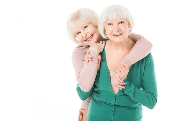 Two senior stylish women hugging isolated on white — Stock Photo