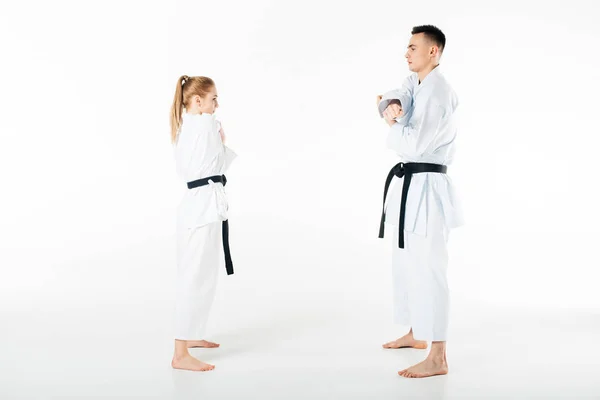 Side view of karate fighters stretching hands isolated on white — Stock Photo