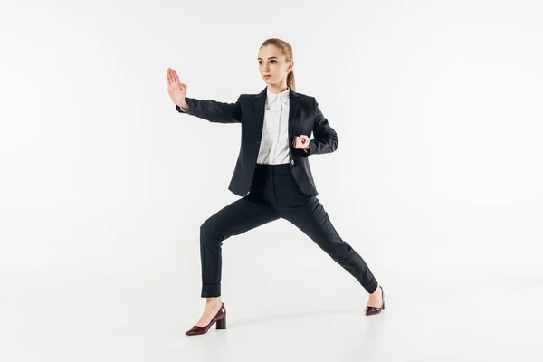 Mujer de negocios ejercicio de karate en traje aislado en blanco - foto de stock