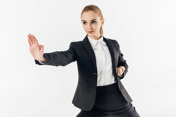 Mujer de negocios entrenamiento karate en traje aislado en blanco - foto de stock