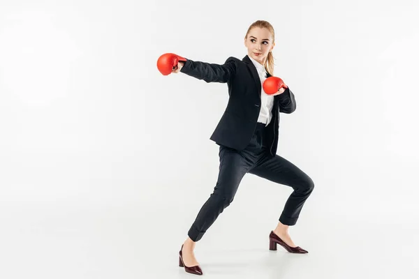 Female karate fighter in suit and red gloves isolated on white — Stock Photo