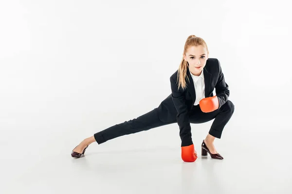 Businesswoman stretching in suit isolated on white — Stock Photo