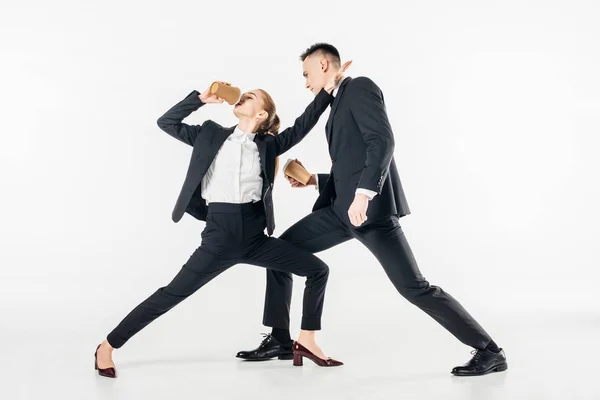 Businesspeople fighting and drinking coffee in suits isolated on white — Stock Photo