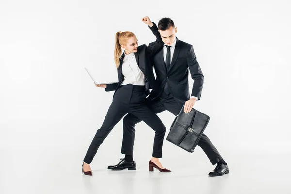 Businesspeople fighting in suits with laptop and bag isolated on white — Stock Photo