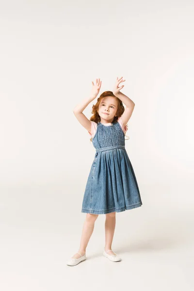 Little stylish child with arms up isolated on white — Stock Photo