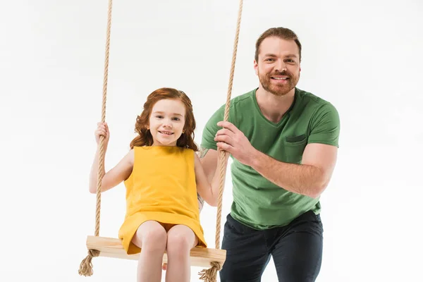 Sorrindo pai montando pequena filha no balanço isolado no branco — Fotografia de Stock