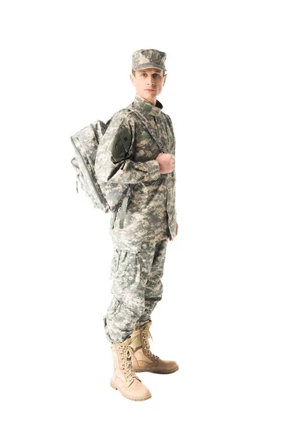 Handsome army soldier in uniform holding backpack isolated on white — Stock Photo