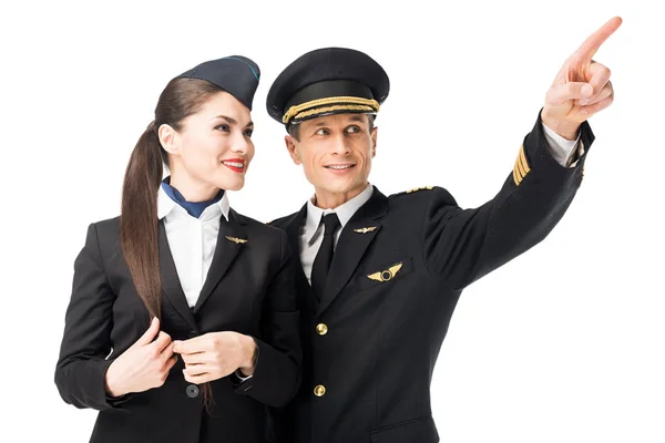 Pilot pointing showing stewardess something isolated on white — Stock Photo