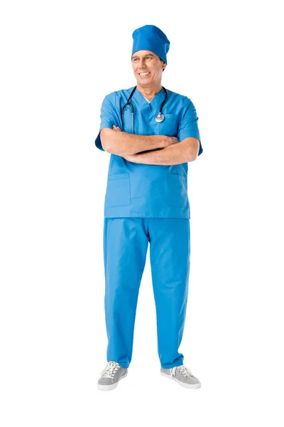 Smiling male doctor with stethoscope standing with arms folded isolated on white — Stock Photo