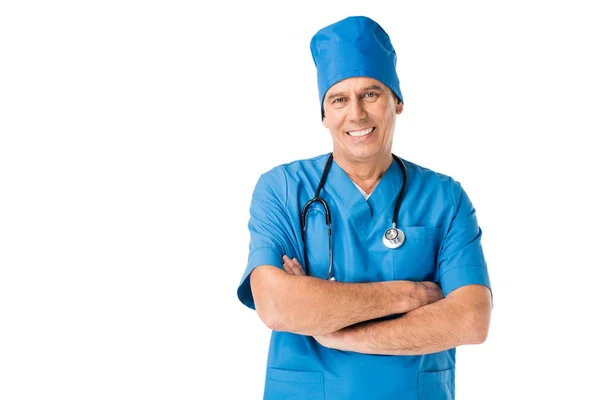 Male doctor in uniform with stethoscope standing with arms folded isolated on white — Stock Photo