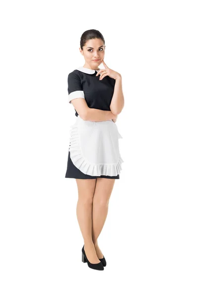 Brunette maid in professional uniform with hand by face isolated on white — Stock Photo