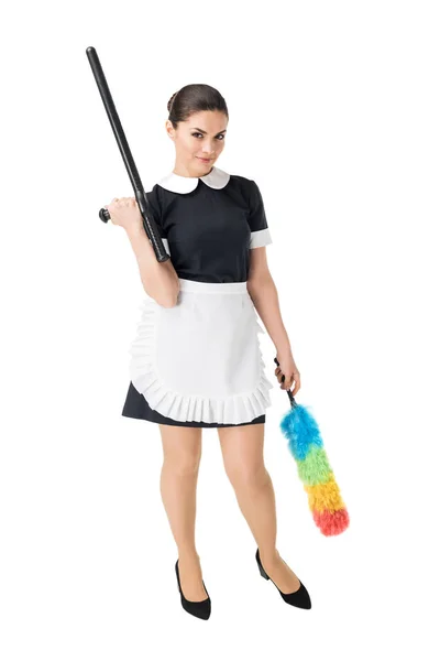 Maid holding baton and colorful duster isolated on white — Stock Photo