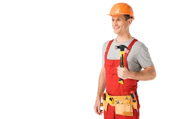 Smiling handyman in overalls holding hammer isolated on white — Stock Photo