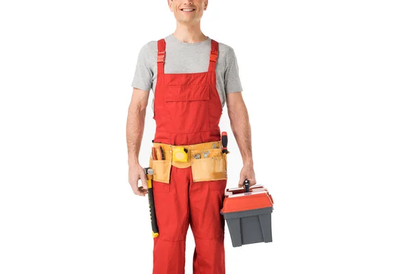 Construtor bonito em uniforme segurando caixa de ferramentas isolado no branco — Fotografia de Stock