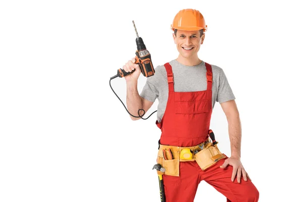 Handsome builder in uniform with tool belt holding drill isolated on white — Stock Photo