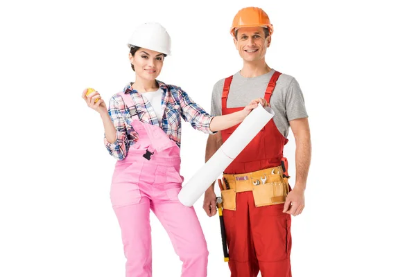 Male and female builders holding blueprint and ruler isolated on white — Stock Photo