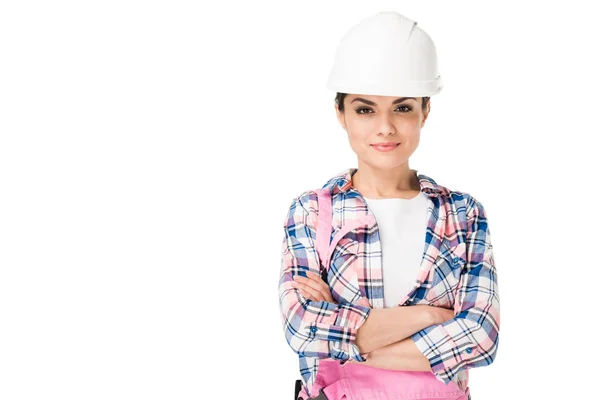 Trabajadora de la construcción sonriente en uniforme con brazos cruzados aislados en blanco — Stock Photo