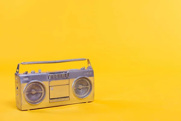 Close-up view of trendy silver tape recorder isolated on yellow — Stock Photo