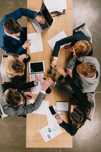 Overhead view of business partners doing construction with pencils at table in office — Stock Photo