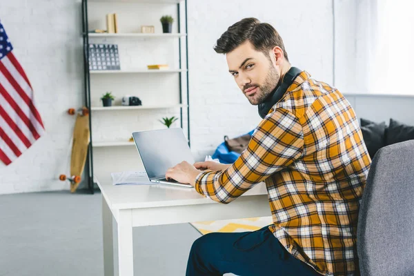 Freelancer working by laptop at home office — Stock Photo