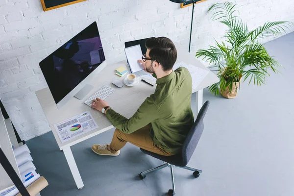 Freelancer working by computer at home office — Stock Photo