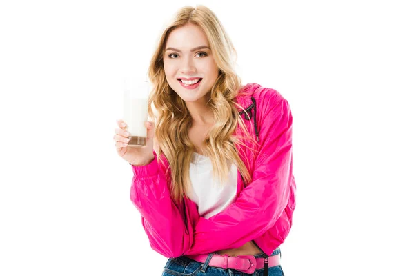 Young girl wearing pink holding glass of milk isolated on white — Stock Photo