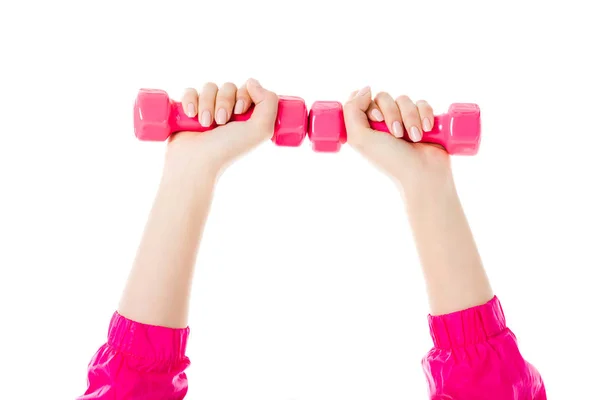 Close-up view of woman lifting pink dumbbells isolated on white — Stock Photo
