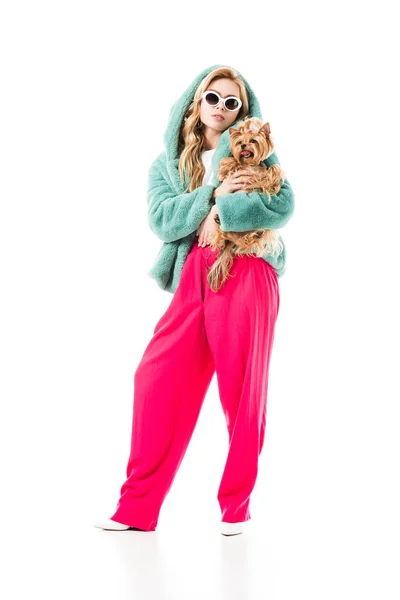 Blonde woman in fur coat holding cute Yorkie isolated on white — Stock Photo