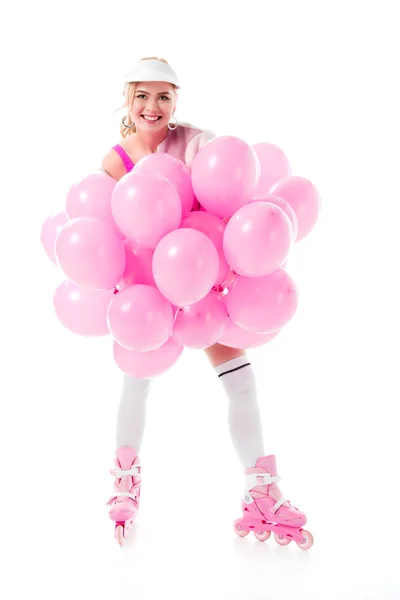 Jeune fille en patins à roulettes tenant des ballons roses isolés sur blanc — Photo de stock